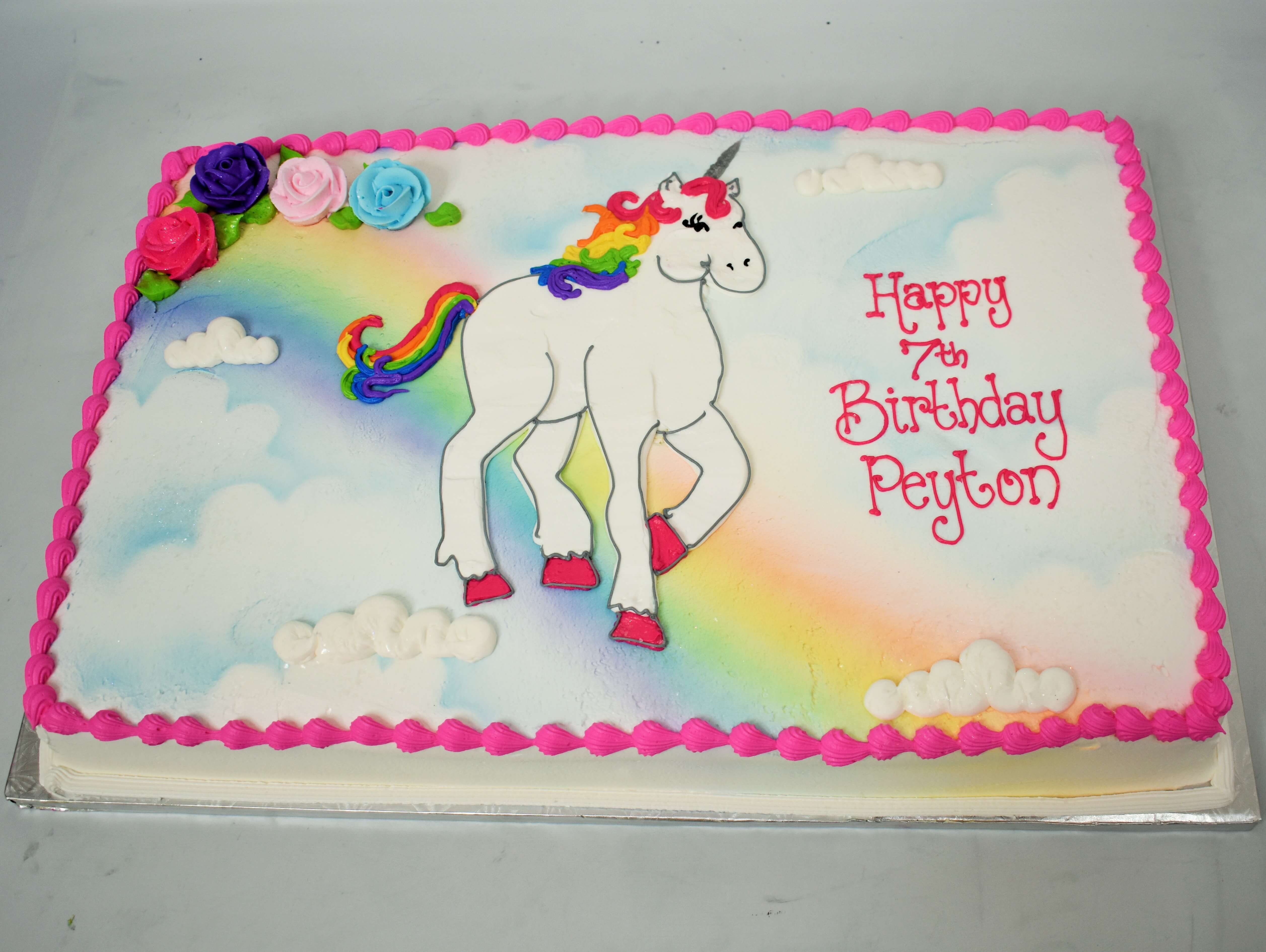 Unicorn Standing on a Rainbow Cake