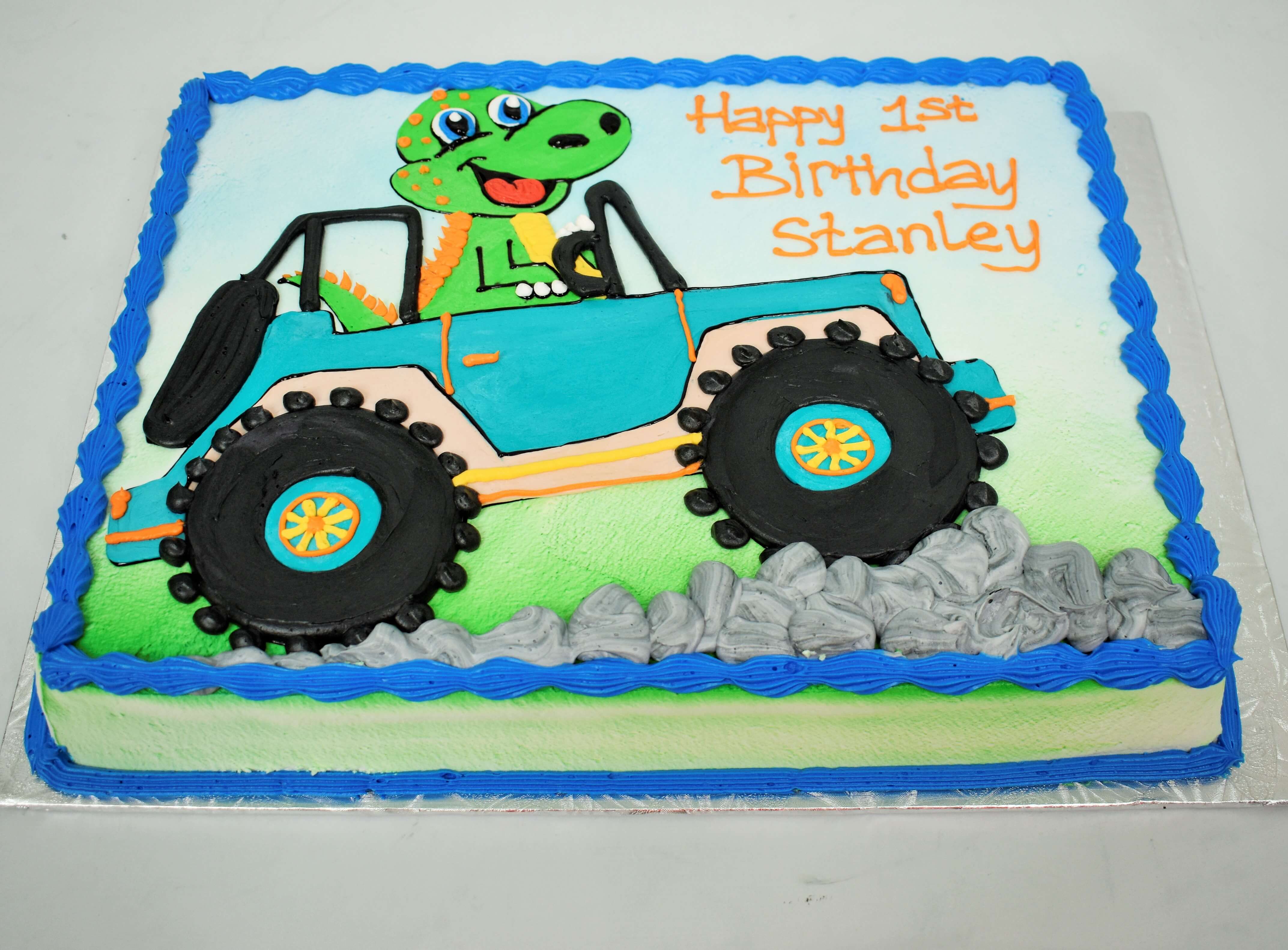 MaArthur's Bakery Custom Cake with a Green Dinasour Driving a Jeep 