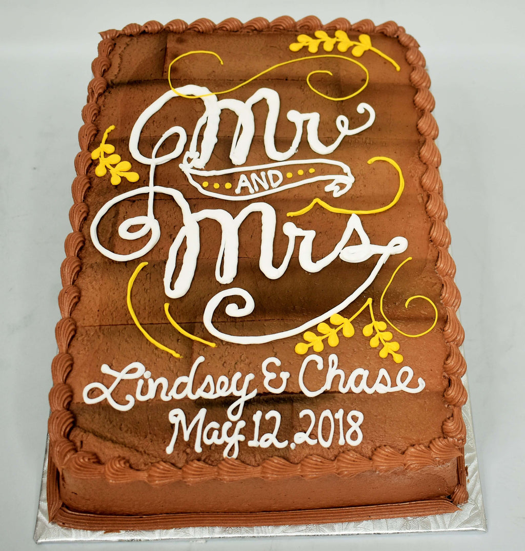 MaArthur's Bakery Custom Cake with Wooden Look Background with Mr. and Mrs. in Fancy Script