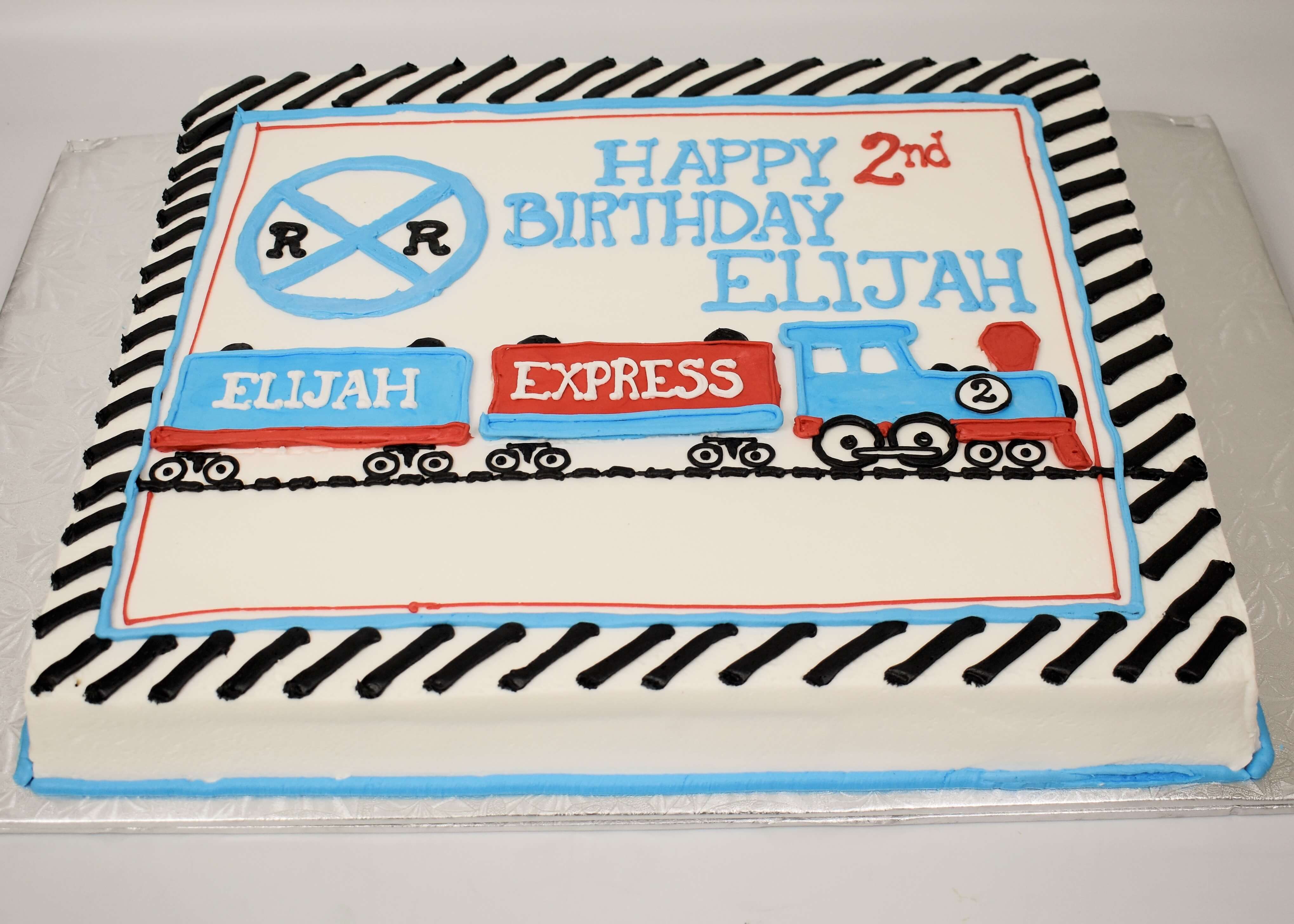 McArthur's Bakery Custom Cake with Blue and Red Train, Rail Road Crossing Sign and Tracks
