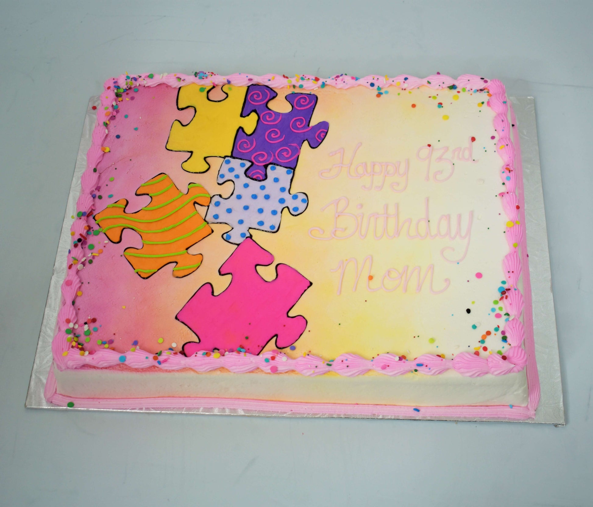 MaArthur's Bakery Custom Cake with Puzzle Pieces, Purpl, Pink, Confetti Sprinkles