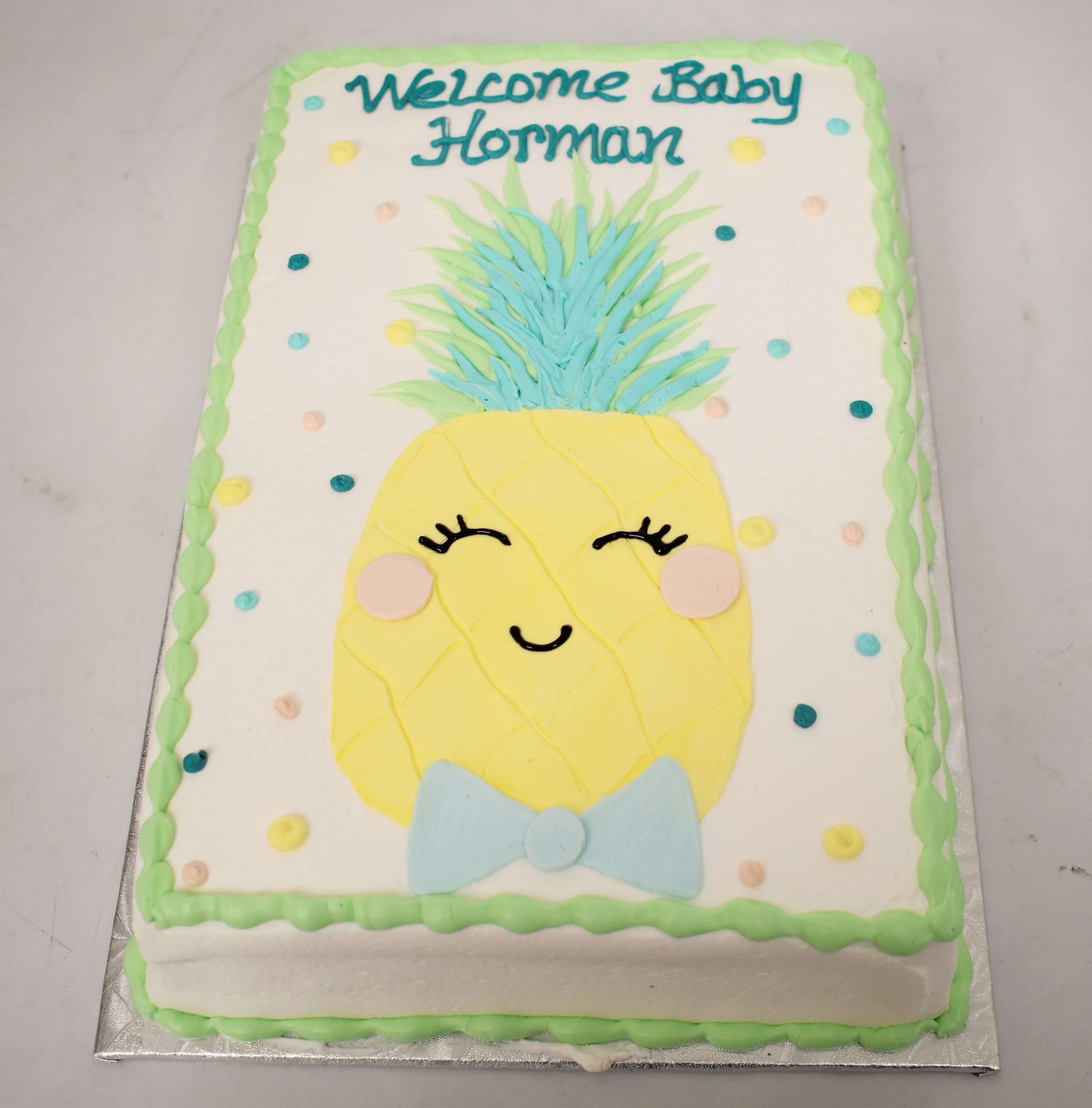 MaArthur's Bakery Custom Cake with Smiling Pineapple, Bowtie, Polka Dots