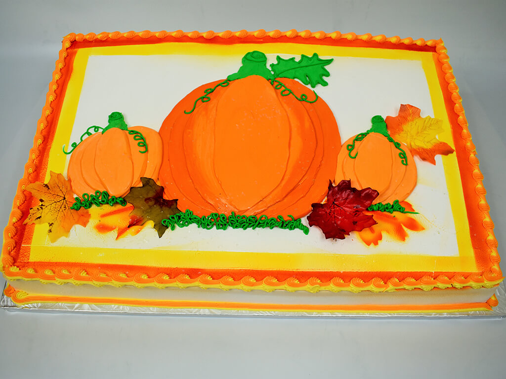 McArthur's Bakery Custom Cake with Fall Theme of Large Orange Pumpkin and Pumpkin Field