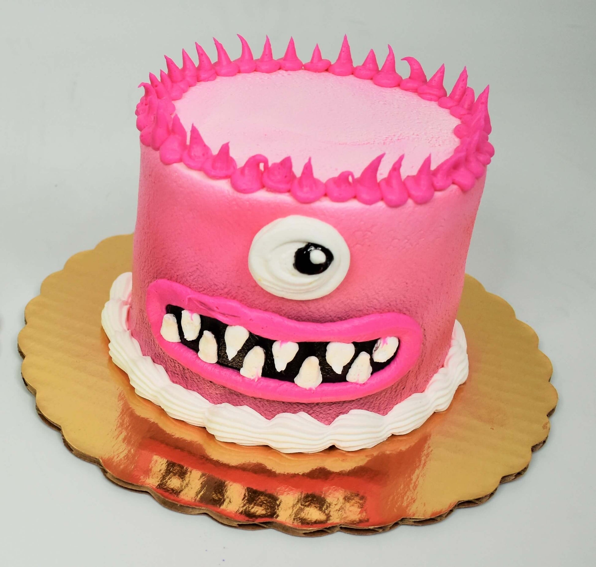 MaArthur's Bakery Custom Cake with Pink Monster Face, One Eye,  Spikey Hair