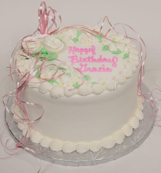 MaArthur's Bakery Custom Cake with White Roses, Green Leaves, Pink Ribbon.