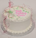 MaArthur's Bakery Custom Cake with White Roses, Green Leaves, Pink Ribbon.
